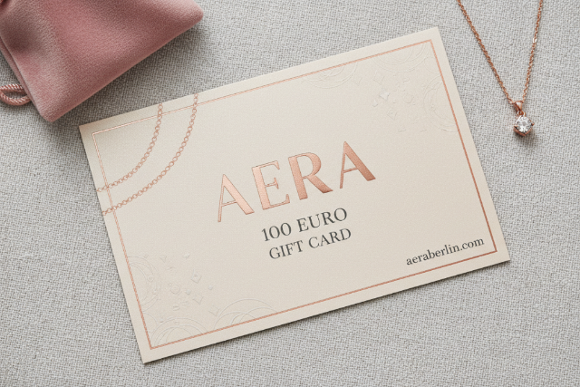 Aera 100 Euro gift card with a necklace on a textured surface